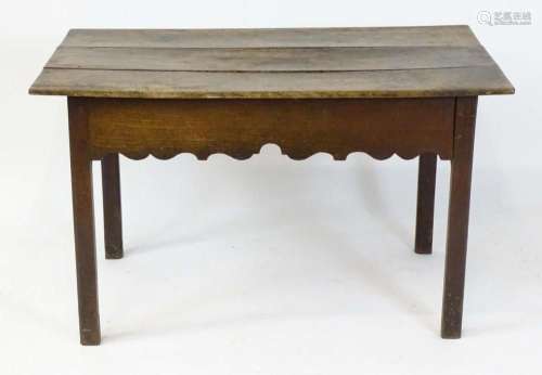 An 18thC oak centre table with a three plank top above a car...