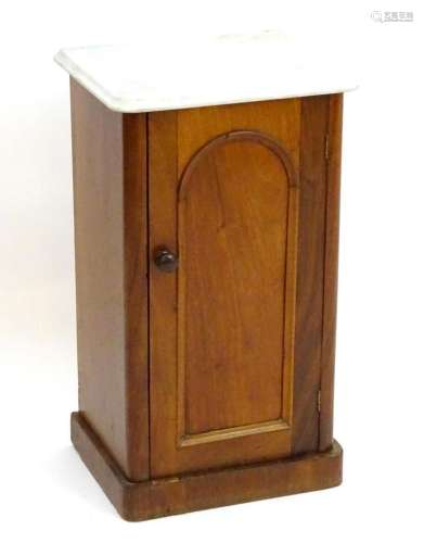 A late 19thC marble top cabinet with an arched panelled door...