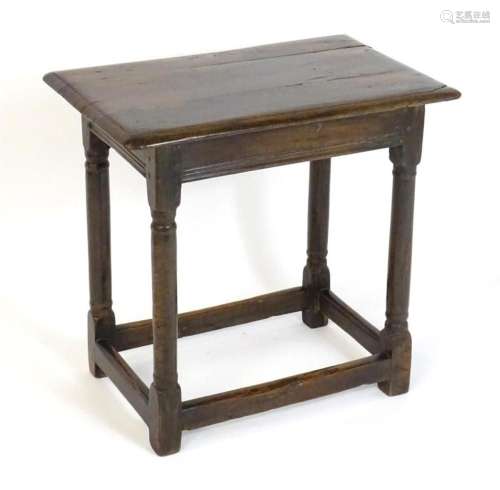 A 17thC oak side table with a moulded top above four turned ...