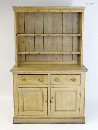 A Victorian pine dresser with a moulded cornice above a two ...