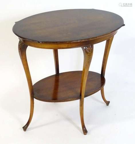 An early 20thC Art Nouveau style occasional table with an ov...