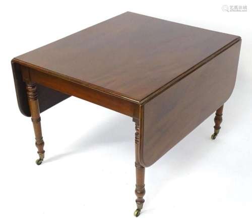 A 19thC mahogany drop flap table raised on four turned taper...