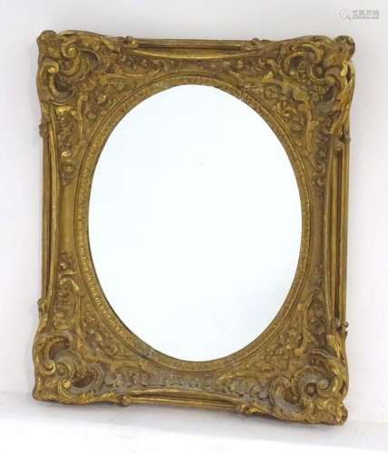 A 19thC giltwood and gesso mirror with a decorative moulded ...