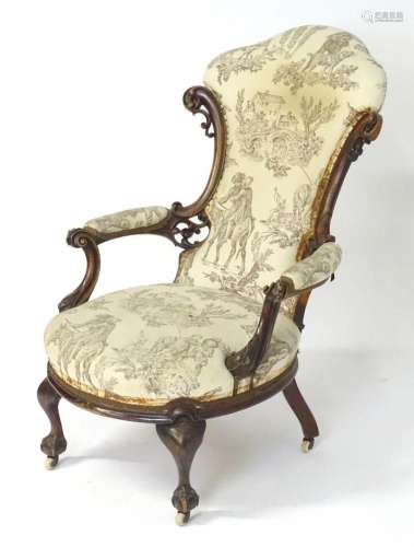 A mid 19thC mahogany open armchair with a carved show wood f...