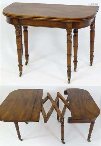 An early 19thC mahogany concertina action dining table with ...