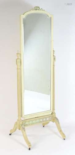 An early 20thC cheval mirror surmounted by carved decoration...