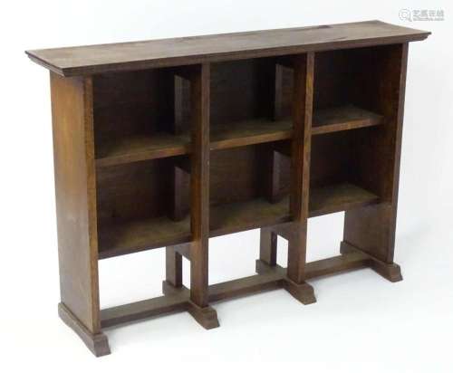 An early / mid 20thC Arts and Crafts bookcase with a moulded...