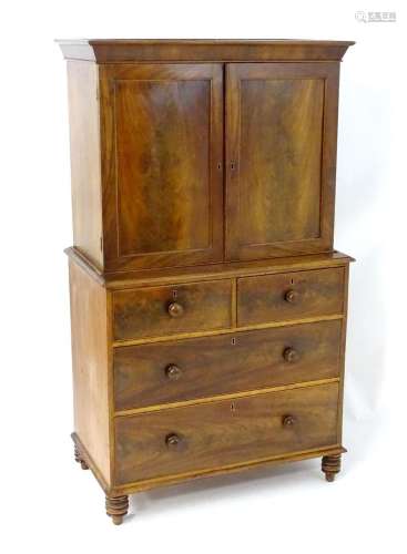 An early 19thC mahogany dwarf press with a moulded cornice a...