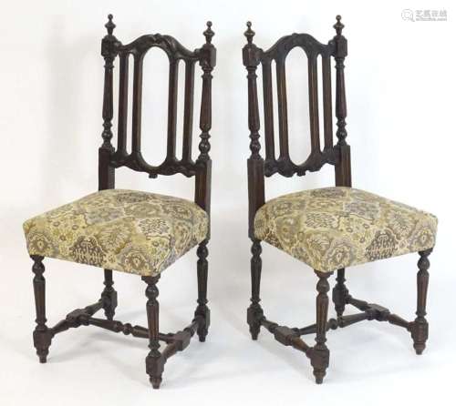 A pair of late 19thC carved oak side chairs surmounted by tu...