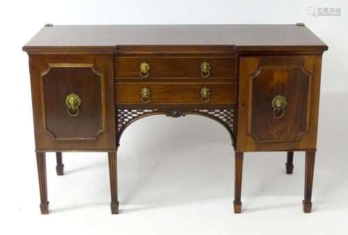 An early 20thC walnut sideboard with an inverted breakfront ...