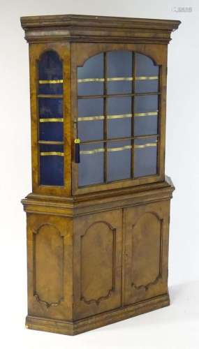 A late 19thC walnut cabinet with a moulded cornice above an ...