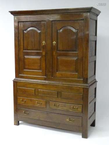An early / mid 18thC oak livery cabinet with a moulded corni...