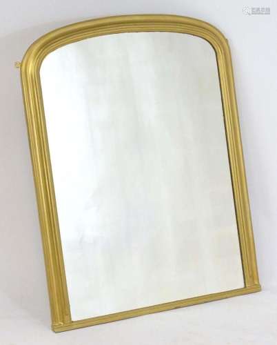 A gilt painted Victorian mirror of ached form. 32" wide...