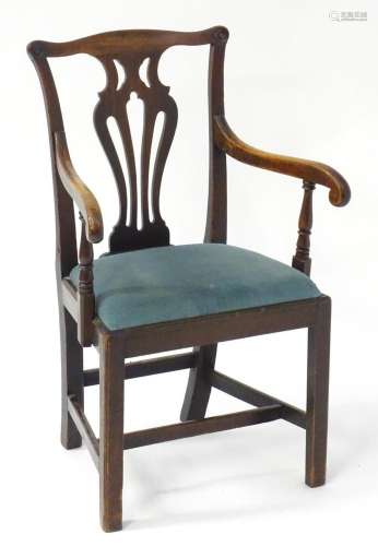 A late 18thC Chippendale style elbow chair with a shaped top...