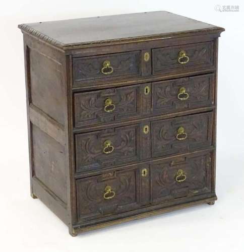 A 17thC and later oak chest of drawers with a carved top edg...