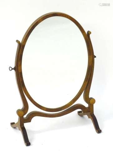 An early / mid 19thC mahogany toilet mirror with shaped supp...