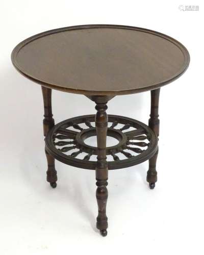 A late 19thC mahogany occasional table with a lazy Susan top...