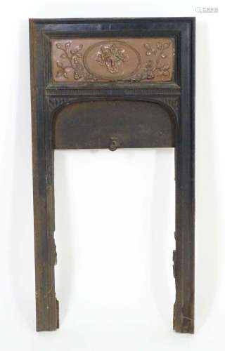 A late 19thC cast iron fire surround, the top with copper pa...