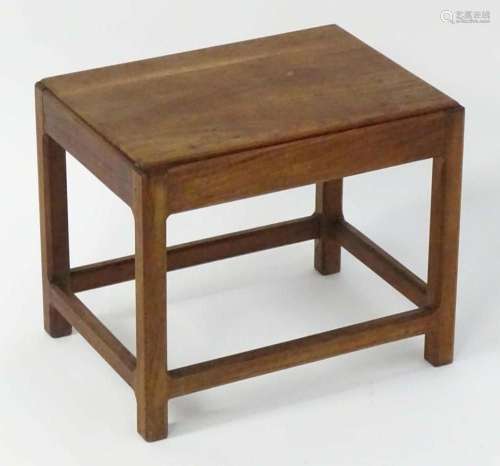A mid 20thC walnut stool with a rectangular top and a peg jo...