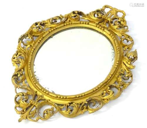 A 19thC giltwood mirror with a pierced floral and beaded sur...