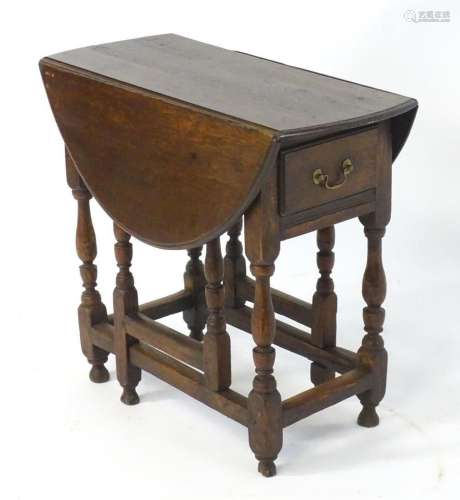 An 18thC oak gateleg table open to form an oval table top ab...