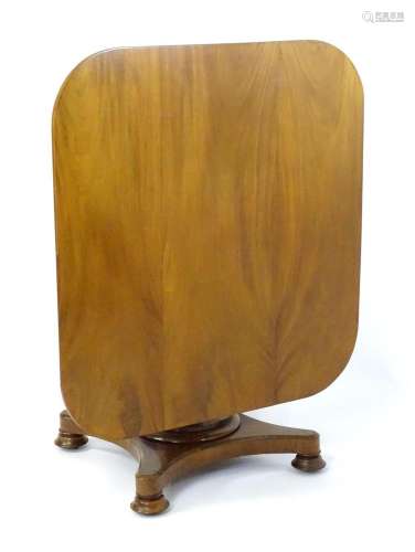 A Victorian mahogany tilt top table with rounded edges and s...