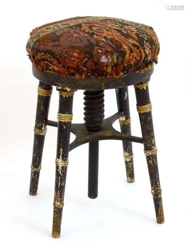 A 19thC ebonised and gilt piano stool with a circular uphols...