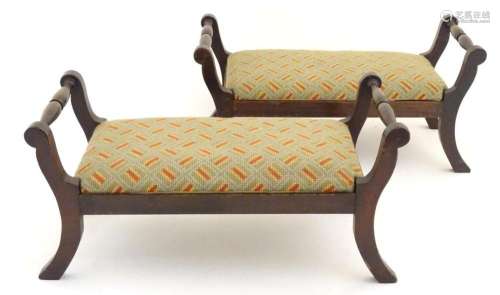 A pair of mahogany footstools with turned rails to either si...