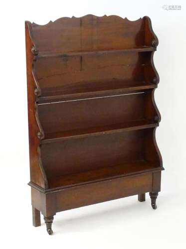 A William IV mahogany waterfall bookcase with a shaped top a...