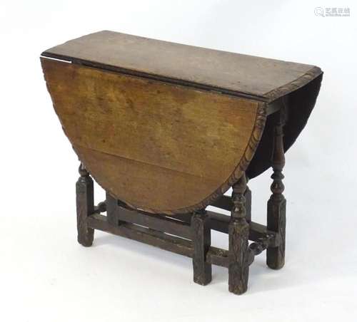 An 18thC oak carved gateleg table, opening up to form an ova...