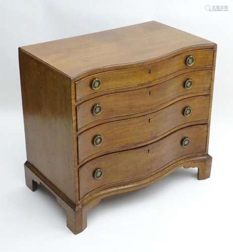 An early 19thC mahogany serpentine fronted chest of drawers,...