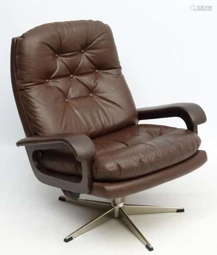 Vintage Retro : A Danish brown leather open arm tilt and swi...