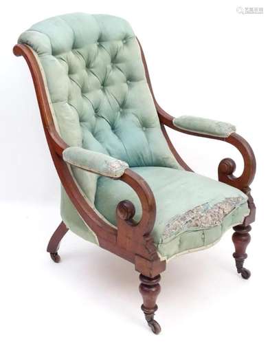 A mid / late 19thC mahogany armchair with a shaped deep butt...