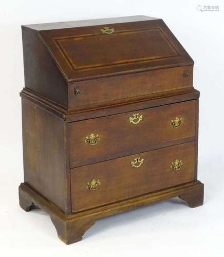 A late 17thC / early 18thC oak two part bureau, having a fal...