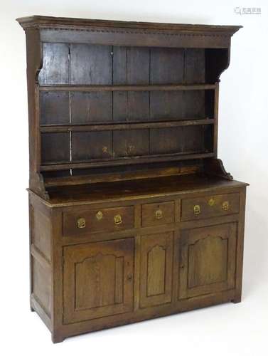 An 18thC oak dresser with a moulded cornice above a dentil c...