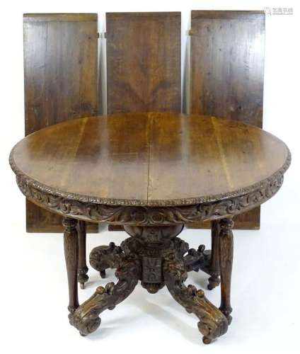 A 19thC oak extending dining table, having a circular top wi...