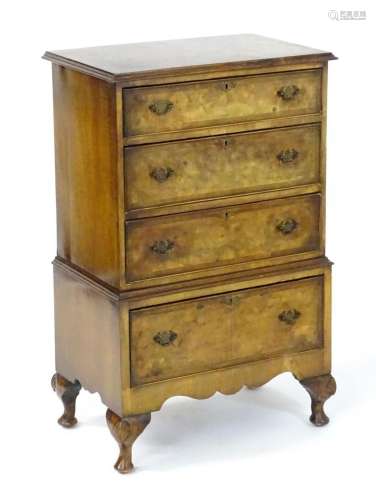 A mid / late 20thC burr walnut chest of drawers, having a mo...