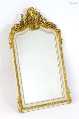 A late 20thC gilt and white painted mirror surmounted by a s...