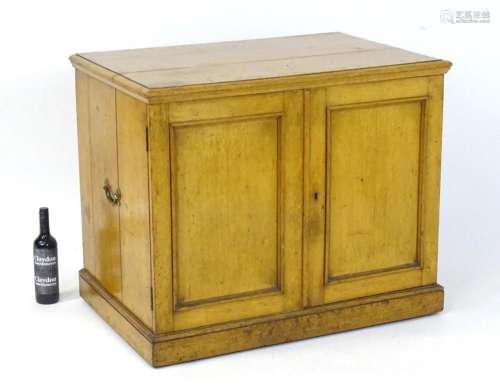 A large oak canteen of cutlery with a moulded top above two ...