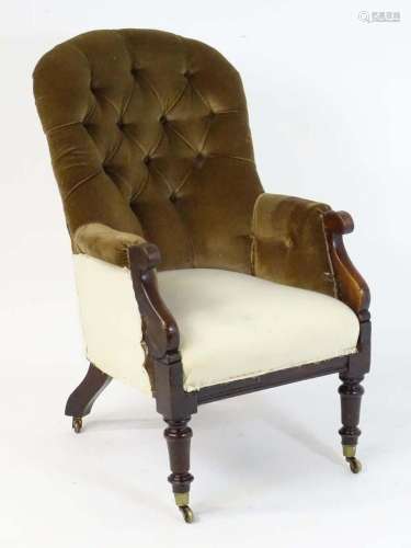 A 19thC armchair with a rounded top and deep buttoned backre...