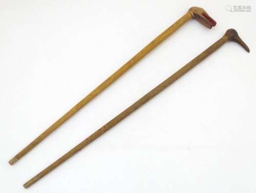 Two early to mid 20thC palm wood walking sticks, each with c...