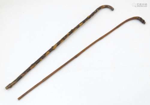 An early 20thC tempered holly walking stick, together with a...