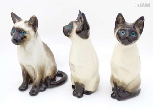 Three Winstanley models of seated Siamese cats with blue eye...