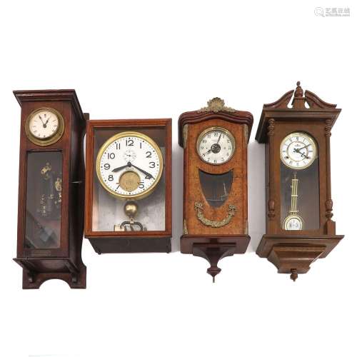 A Collection of 4 Electric Wall Clocks
