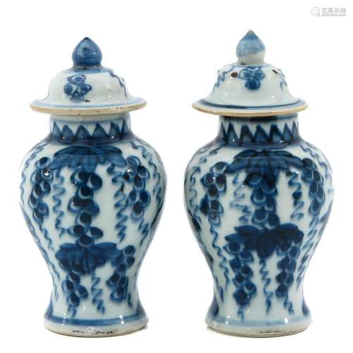 A Pair of Blue and White Vases with Covers