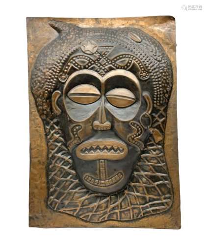 Copper panel embossed with a design of an African mask