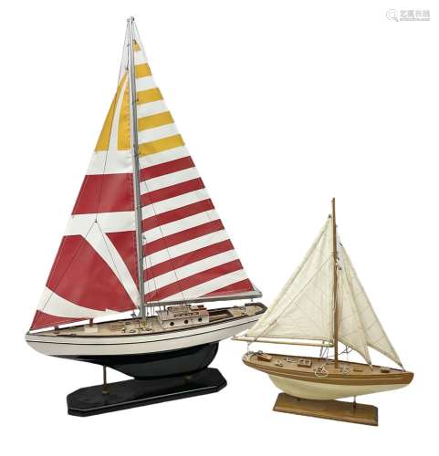 Wooden kit built model yacht with sails and mounted on woode...