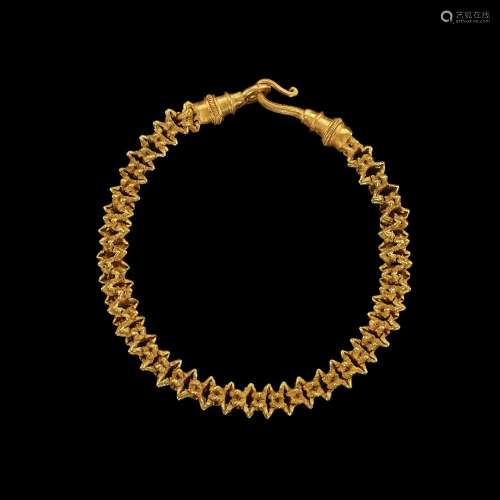 . A gold ‘floral’ bracelet with an ornate hoop Khmer, 10th -...