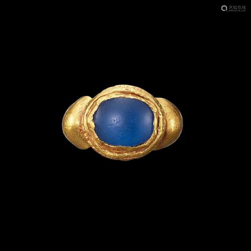 . A solid gold and ancient blue glass ring Possibly Khmer, 7...