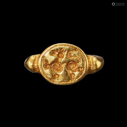 . A solid gold ring with an incised bezel of a rampant lion ...